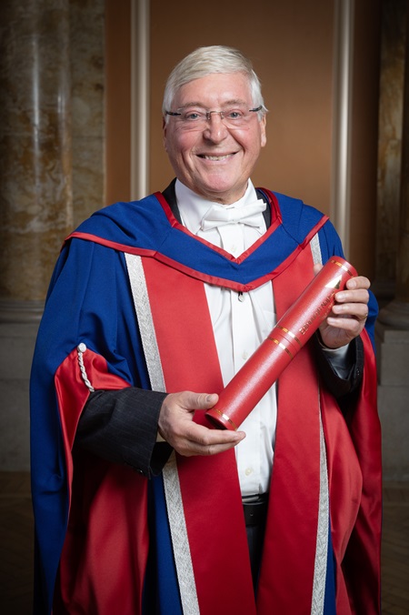 Edinburgh Napier University honorary graduate Alex Linkston posing with his degree