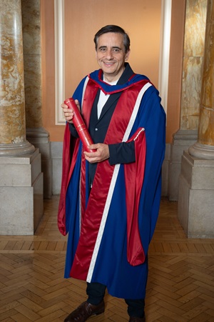 Alex Poots posing with his honorary degree