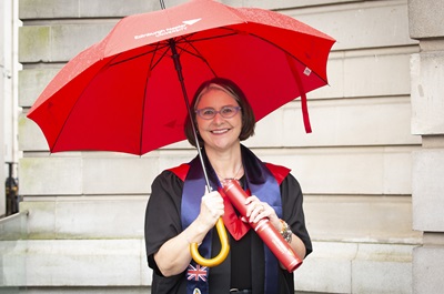 Allison Lovinggood poses with her Business MBA, after travelling to graduation from the Cayman Islands