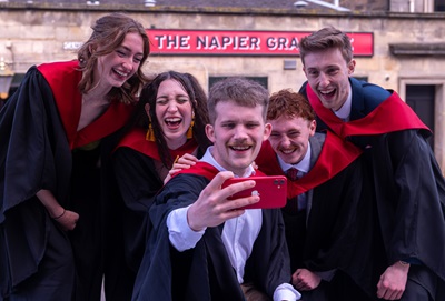 Students taking a selfie outside The Napier Graduate, the re-branded pub to mark Edinburgh Napier University's graduations