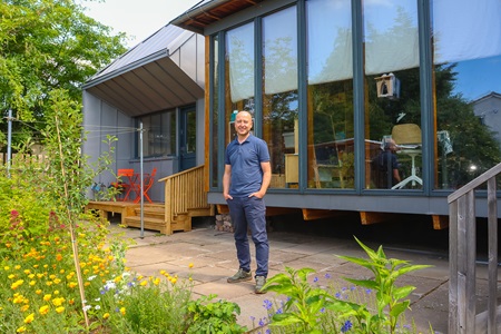Robert Hairstans standing in front of a house