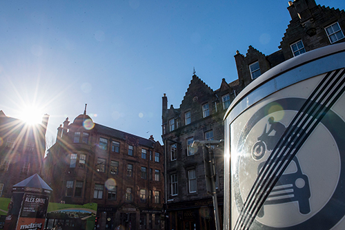 Sun shines on a no vehicle sign in Edinburgh