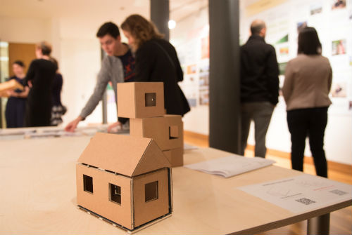 General view of BeX exhibition with exhibit in the foreground, people milling in background