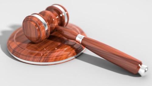 brown wooden gavel against white background