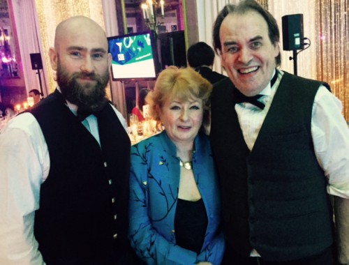 Three people in formal attire at the Cyber Awards