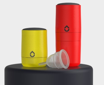 A yellow cylinder beside a taller red cylinder with a funnel-type device laid down beside it