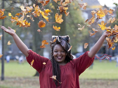 Florence Clarke throwing leaves in the air