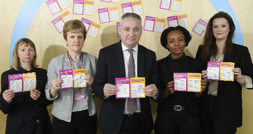 Line-up of five people holding stickers including Professor Andrea Nolan and higher education minister Richard Lochhead