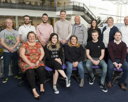 Thirteen Graduate Apprentices in two rows on induction day at the Craiglockhart campus 