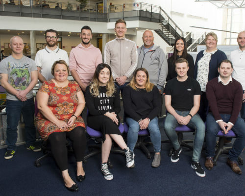 Thirteen Graduate Apprentices in two rows on induction day at the Craiglockhart campus
