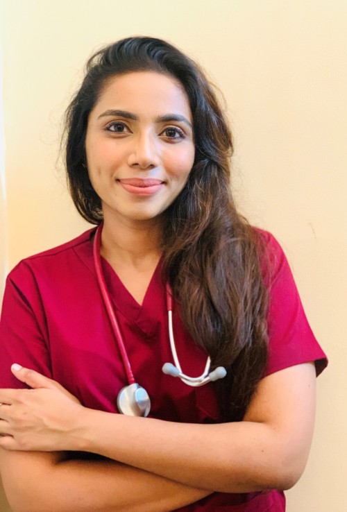 Portrait of Hashani in maroon medical clothing 