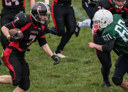 An Edinburgh Napier Knights American football player running with the ball under their arm