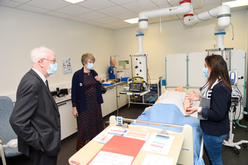 Lord and Lady Wallace at bedside in the learning ward in the clinical skills centre with lecturer Michelle O'Reilly