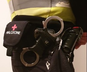 Close-up of pouch containing Naloxone spray attached to a police officer's belt