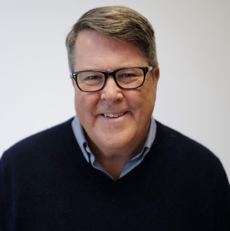 head and shoulders of Pete Jaco, a bespectacled man in a dark jersey