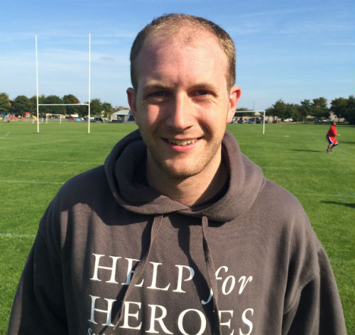 Portrait of Rob Worboys on sports field wearing Help for Heroes hoodie
