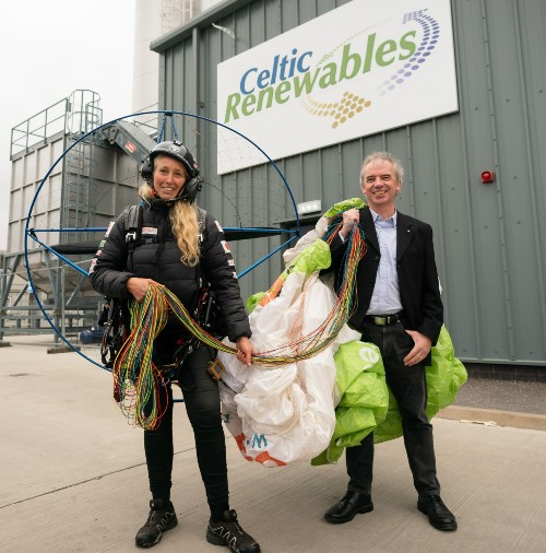 Sacha Dench with her paramotor outside the plant and underneath the Celtic Renewables sign with Martin Tangney