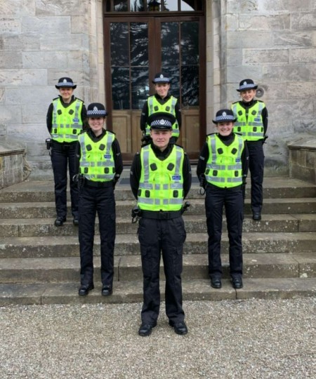 Six students on steps in 1-2-3 formation in Special Constables hi-vis uniform