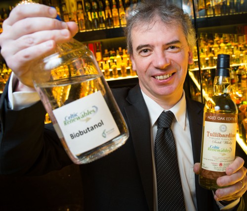 Professor Martin Tangney holding two bottles