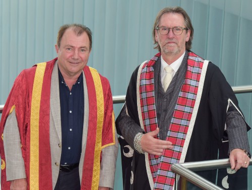 Will Whitehorn and David Eustace in colourful ceremonial robes inside the Sighthill campus building  