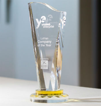 Close up of tall glass Young Enterprise trophy