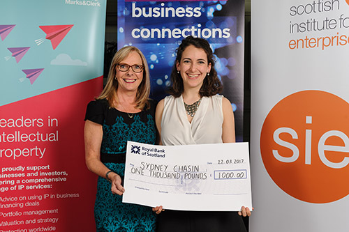 Sydney Chasin holding the &pound;1,000 cheque