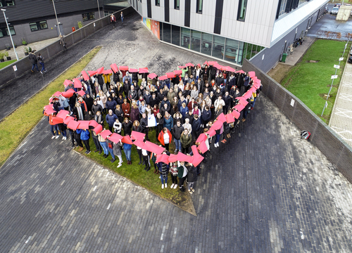 Group of students gathered in a heart shape