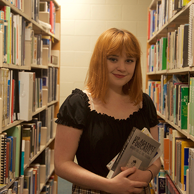 Image of Caitlin Wallace in a library