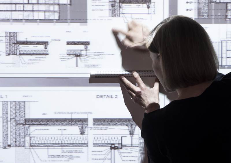 Woman using interactive screen.