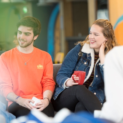 Male and female student in accommodation common area