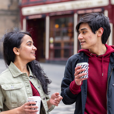 Male and female student drinking coffee in Edinburgh