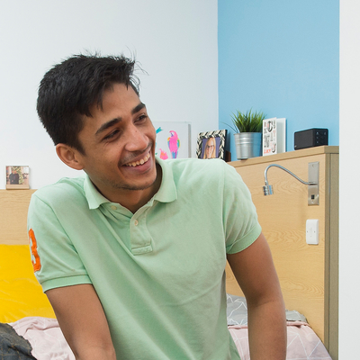 Male student in student accommodation bedroom