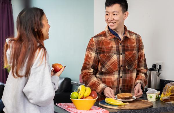Two students having a conversation over breakfast inside our Edinburgh Napier student accommodation. 