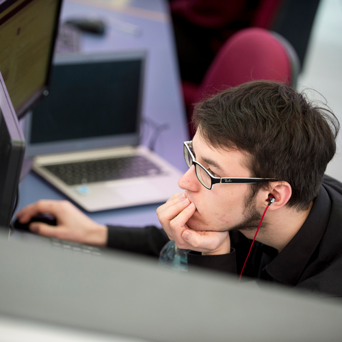 Freelancer working on two computers.