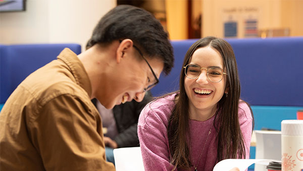 two students smiling and laughing