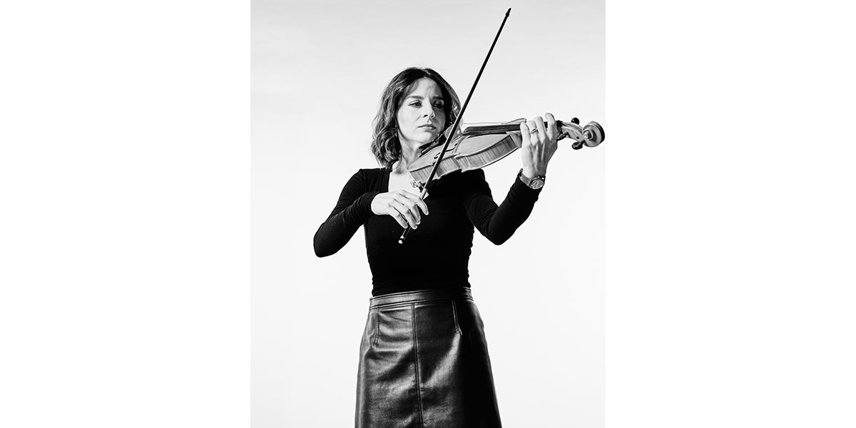 Arianna, a music phd student and professional violinist, plays her instrument