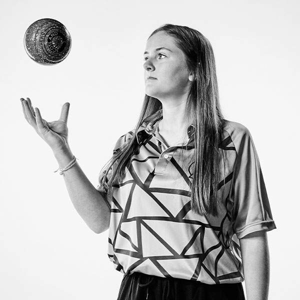 Beth Riva, lawn bowls world champion and law student, tosses her bowl in the air