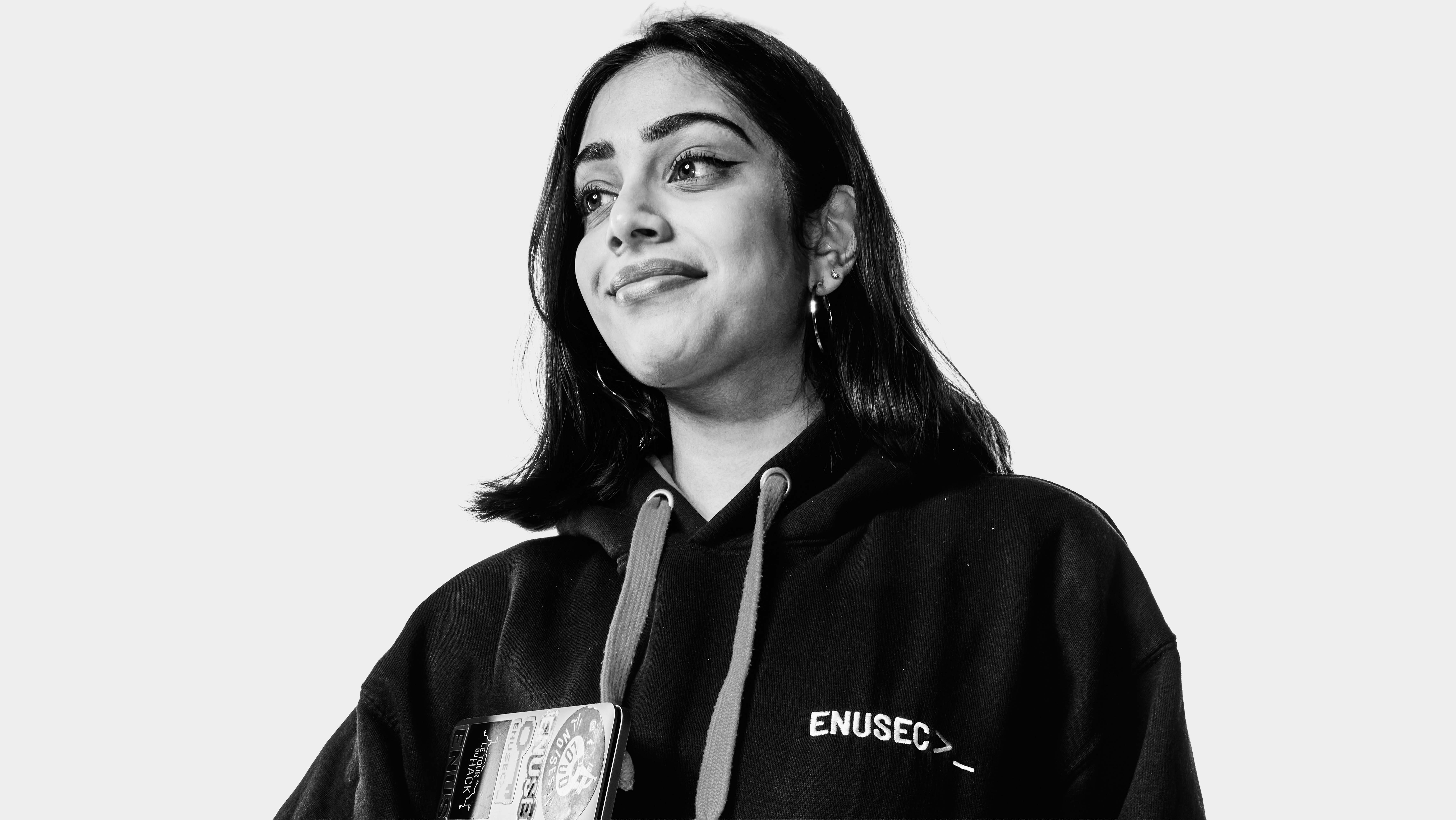 Joyee, a cybersecurity student at edinburgh napier university, stands confidently in this black and white image