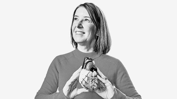Professor Lis Neubeck, Head of the Centre for Cardiovascular health, holds a 3d model of a heart.