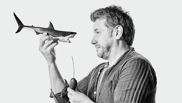 James thorburn with toy shark in black and white