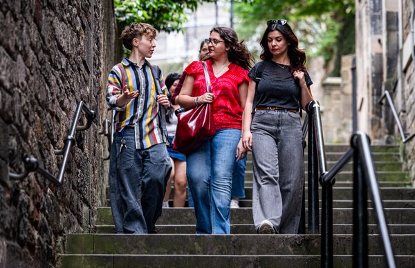 An image of a group of Edinburgh Napier students walking and talking as they do sight-seeing around central Edinburgh. 