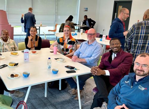 Doctoral College students around a desk
