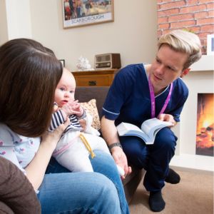 Nurse in discussion with mother and child 