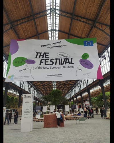 Festival banner hanging from within a busy building's ceiling