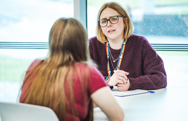 student receiving support from a staff member