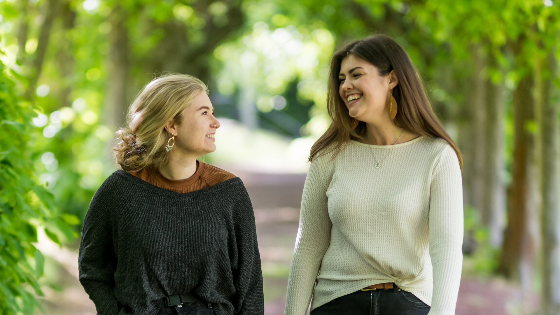 two international USA students walking through nature in edinburgh in conversation
