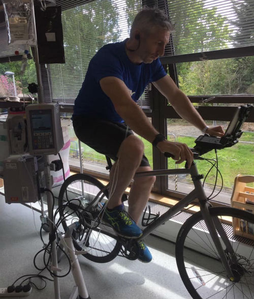 Cancer patient Gary MacDougall exercises on his bike