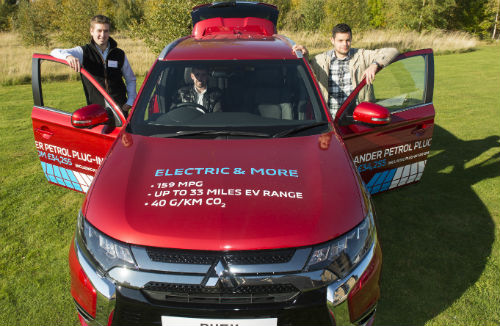 Rory Dowell, Colin Cochrane and Keith Alcock getting a close-up look at a new electric vehicle